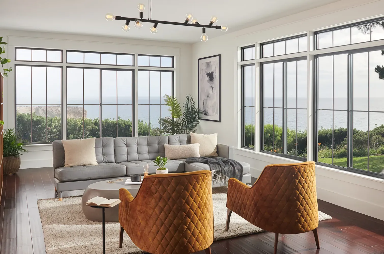 Long windows in living room with yellow chairs